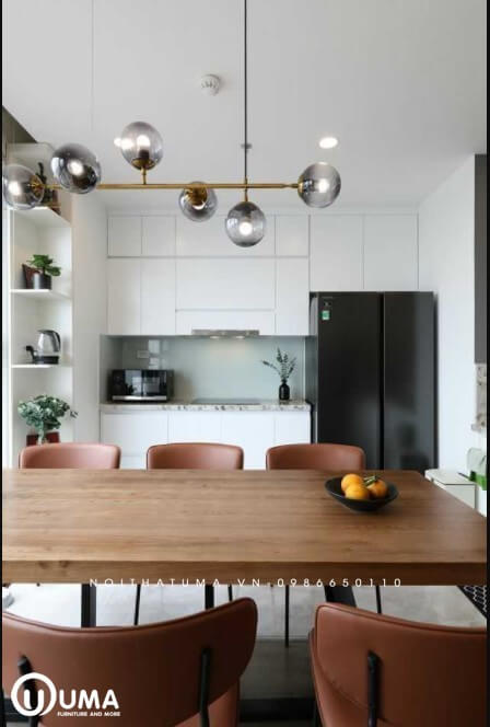 Bàn ăn được thiết kế ngay giữa không gian, giúp ngăn giữa phòng bếp và không gian phòng khách