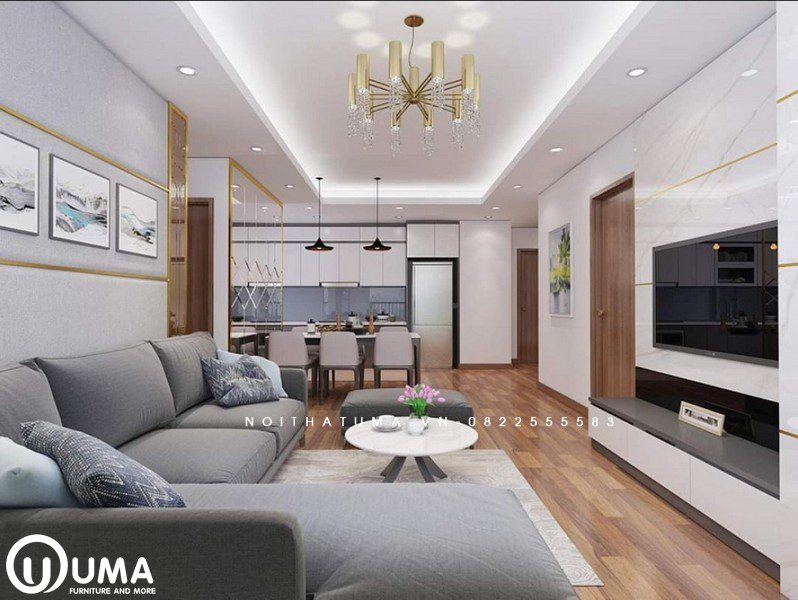 Phòng khách được thiết kế khá nhẹ nhàng và ấn tượng, với bộ sofa màu xám chữ L.